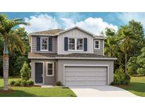 Two-story home with gray stucco and siding, complemented by blue shutters and a two-car garage at 746 Lake Dell Ave, Dundee, FL 33838