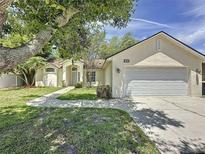 Well-maintained home featuring lush landscaping, a two-car garage, and a classic suburban appeal at 86 Blackberry Creek Dr, St Cloud, FL 34769