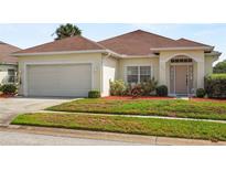 Charming single-story home with a well-maintained lawn and two-car garage at 906 Berwick Dr, Davenport, FL 33897
