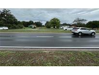 Street view showing a highway and a silver SUV at 1886 Pleasant Hill Rd, Kissimmee, FL 34746