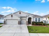 Beautiful single-story home featuring a three-car garage and well-maintained landscaping at 1951 Partin Terrace Rd, Kissimmee, FL 34744