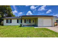Charming single-story home featuring a well-maintained lawn, covered entry, and attached one-car garage at 2127 Patrick St, Kissimmee, FL 34741