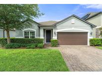 Charming single-story home featuring manicured lawn and a two-car garage at 3424 Middlebrook Pl, Harmony, FL 34773