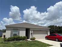 Well maintained home with a neutral color scheme, landscaping and a two-car garage at 3476 Yarian Dr, Haines City, FL 33844