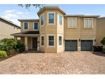 Charming two-story home with a two-car garage and brick paved driveway at 7616 Brookhurst Ln, Kissimmee, FL 34747