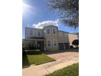 Charming two-story home boasts a well-manicured lawn and a spacious two-car garage at 7616 Brookhurst Ln, Kissimmee, FL 34747