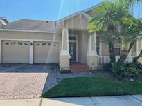 Charming, single-story home features a two-car garage and a meticulously maintained front yard at 9721 Old Patina Way, Orlando, FL 32832