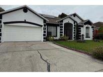 Charming home with a well-manicured lawn and a two-car garage at 216 Boxwood Dr, Davenport, FL 33837