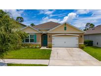 Inviting single-story home with a well-manicured lawn, charming curb appeal, and a two-car garage at 2726 Harmonia Hammock Rd, Harmony, FL 34773
