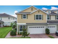 Charming townhouse boasts a two-car garage and well-maintained landscaping at 3603 Sanctuary Dr, St Cloud, FL 34769