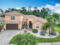 Stunning home with a tile roof, paver driveway, and a lush tropical landscaped yard at 4109 Vessel Ct, Kissimmee, FL 34746