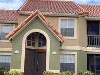 Charming condo with arched entryway, terracotta roof and lush landscaping at 429 Fountainhead Cir # 223, Kissimmee, FL 34741