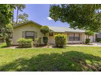 Charming home exterior showcasing lush landscaping, a well-manicured lawn, and natural light at 4307 Oak Ct, St Cloud, FL 34769