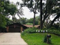 Charming single-story home with a well-manicured front yard and mature trees offering plenty of shade at 655 Vine Ct, Apopka, FL 32703