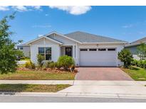 Charming single-story home with manicured landscaping and a brick paver driveway at 6651 Syreeta Ln, Harmony, FL 34773