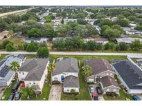 Charming two-story home featuring a well-maintained yard and inviting curb appeal, located in a quiet neighborhood at 824 Bloomingdale Dr, Davenport, FL 33897