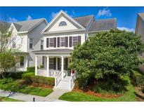 Charming two-story home featuring a welcoming porch and a well-maintained landscaped yard at 1236 Aquila Loop, Celebration, FL 34747