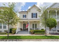 Charming two-story home with a welcoming front porch and well-manicured landscaping at 1592 Castile St, Celebration, FL 34747