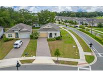 Inviting one-story home featuring manicured lawn and a brick paved driveway, providing great curb appeal at 1598 Whitewood Ct, Kissimmee, FL 34747