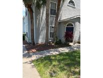 Charming two-story condo with a landscaped front yard and well-maintained exterior at 1608 Columbia Arms Cir # 126, Kissimmee, FL 34741