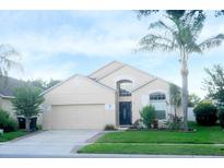 Charming single-story home with a lush, landscaped front yard and an attached two-car garage at 2268 Victoria Falls Dr, Orlando, FL 32824