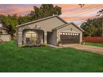 Charming single-Gathering home with a well-manicured lawn and cozy front porch at 2700 Palm Isle Way, Orlando, FL 32829