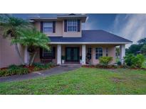 Inviting front entrance showcases meticulously landscaped yard and charming architecture at 2851 Granada Blvd, Kissimmee, FL 34746