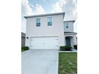 Charming two-story home with a two-car garage, manicured lawn, and appealing curb appeal at 2915 Turnstone, St Cloud, FL 34773