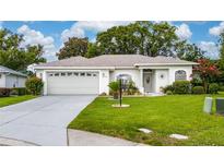 Charming single-story home featuring a manicured lawn and a two-car garage at 3161 Timberly Ln, Lakeland, FL 33810