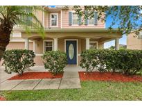 Charming home featuring a covered front porch with stylish columns and well-maintained landscaping at 3335 Whistling Trl, St Cloud, FL 34772