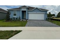 Charming single-story home with a well-manicured lawn and a two-car garage at 522 Feltrim Manor Rd, Haines City, FL 33844