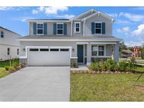 Charming two-story home featuring gray siding, stone accents, an attached two-car garage and a well-manicured front lawn at 640 Summit River Dr, Apopka, FL 32712