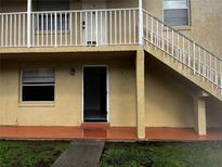 Exterior view of the property featuring a stairway and front entrance at 731 Michigan Ct # 1, St Cloud, FL 34769
