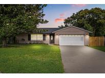 Charming single-story home featuring a well-manicured lawn and an attached two-car garage at 736 Forest Glen Ct, Maitland, FL 32751
