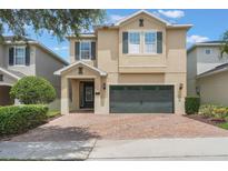Charming two-story home featuring a brick driveway and a well-maintained lawn, perfect for Gathering living at 331 Pendant Ct, Kissimmee, FL 34747