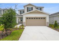 Charming two-story home with a two-car garage and well-maintained landscaping at 208 Flag Lilly Ln, Umatilla, FL 32784