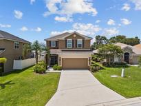 Charming two-story home featuring a well-manicured lawn and an inviting double-car garage at 3991 Island Lakes Dr, Winter Haven, FL 33881
