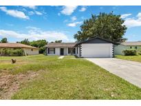 Charming single-Gathering home with a well-maintained lawn and a two-car garage at 406 Long Dr, Kissimmee, FL 34759