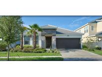 Charming single-Gathering home featuring a lush lawn, gray roof, and an attached two-car garage at 4504 Monado Dr, Kissimmee, FL 34746