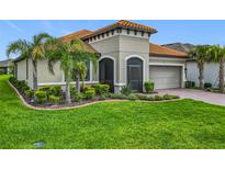 Charming home with lush landscaping, well-maintained lawn, and a tile roof at 605 San Augusto Dr, Kissimmee, FL 34759