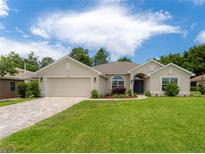 Charming single-story home with well-manicured lawn and a brick driveway at 6644 Sw 179Th Court Rd, Dunnellon, FL 34432