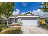 Charming single-story home featuring an attached two car garage and well-maintained lawn at 2146 Fish Eagle St, Clermont, FL 34714