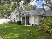 Charming single-Gathering home featuring a well-manicured lawn, lush landscaping, and inviting curb appeal at 2225 Maryday Ct, Orlando, FL 32812