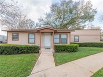 Charming single-story home featuring manicured landscaping and a welcoming front porch at 405 Eron Way # 39, Winter Garden, FL 34787