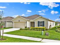 Attractive single-story house with a lovely landscaped front yard and a convenient two-car garage at 4492 Bluff Oak Loop, Kissimmee, FL 34746