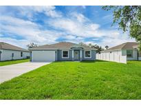 Charming single-story home featuring a well-manicured lawn and a classic two-car garage at 4615 Madison Ave, Lake Wales, FL 33859