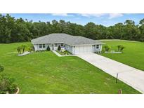 Charming single-story home with a well-manicured lawn, beautiful landscaping, and a two-car garage at 911 Mendoza Ln, Kissimmee, FL 34758