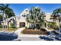 Welcoming clubhouse showcasing an inviting entrance, lush landscaping, and distinctive architectural details at 1023 S Hiawassee Rd # 4017, Orlando, FL 32835