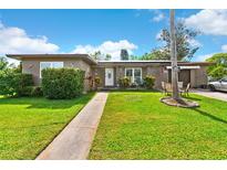 Charming single-story home with a well-manicured lawn, sidewalk, and inviting front entrance at 1566 Providence Blvd, Deltona, FL 32725