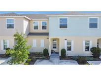 Charming townhome featuring neutral colors, decorative shutters, and a well-maintained front yard at 4850 Coral Castle Dr, Kissimmee, FL 34746